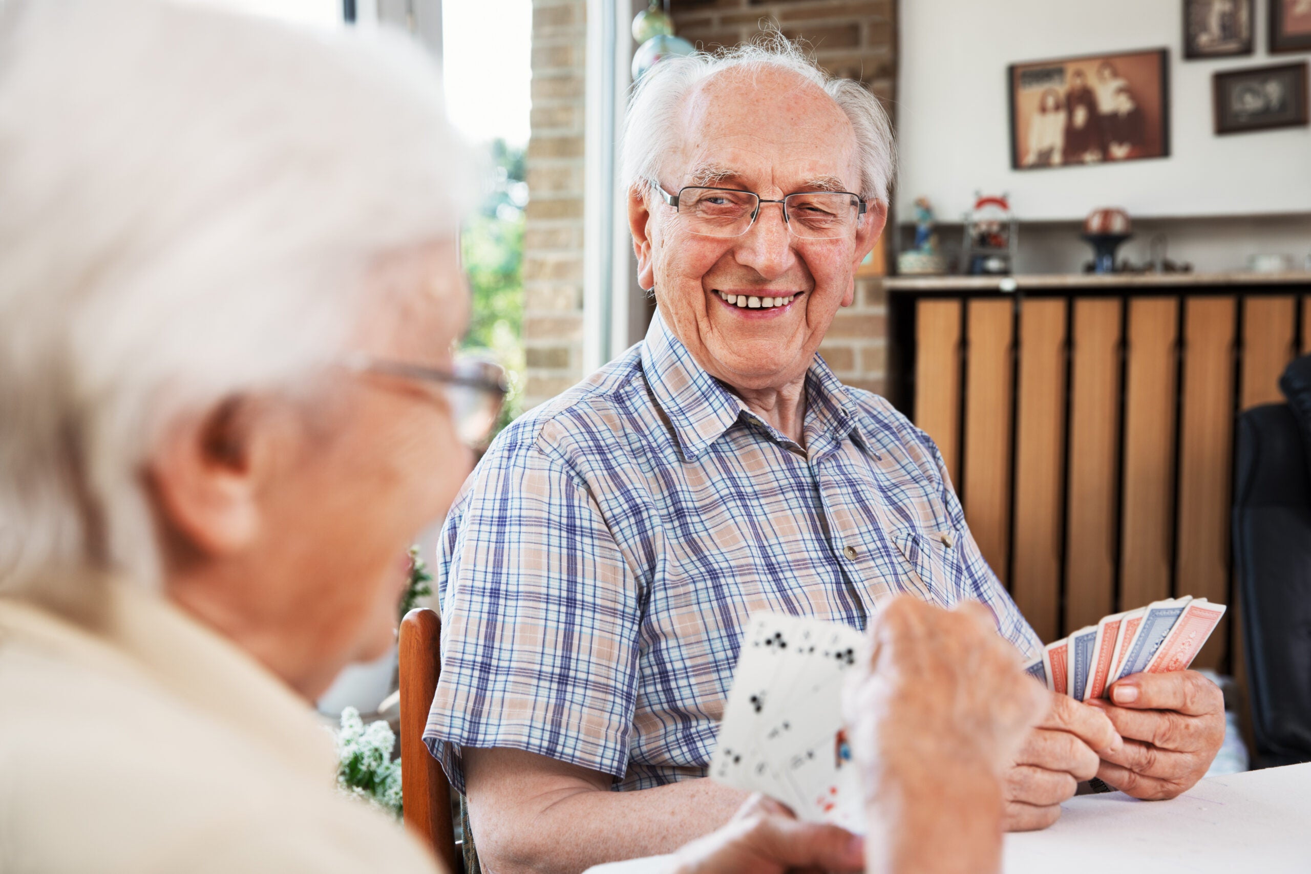 elderly people playing cards