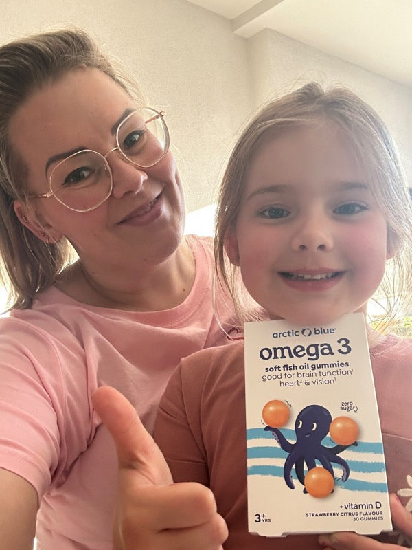 Lisa van Spronsen en haar dochter met een verpakking Arctic Blue omega 3 gummies